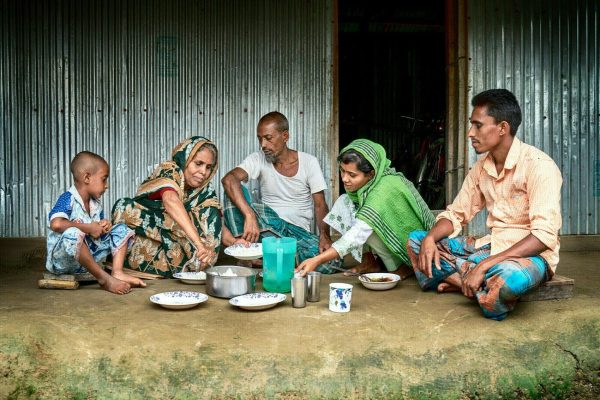 Fatema Begum is having lunch with her family, with her daughter and granddaughter.

Fatema is 50 years old and has been living with leprosy for twenty years now. She lives with her husband and extended family members. Fatema stays at home and looks after her young grandchildren. She received treatment from The Leprosy Mission's DBLM Hospital and still visits sometimes if her health deteriorates.

She says, “Leprosy brings suffering. People have to go from hospital to hospital. I also had to go to many hospitals, then I went to the Mission hospital, after much suffering I found a way to get treatment. I only hope and pray that my children and grandchildren do not suffer from this disease.”

She is also part of a self-help group.